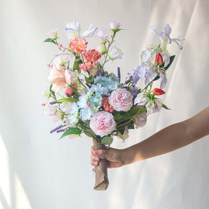 Realistic artificial Peony flower arrangement, handmade, table decor. Colorful floral bouquet in hand.