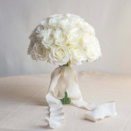 High-Quality artificial cream white silk rose bridal bouquet with a delicate ribbon.