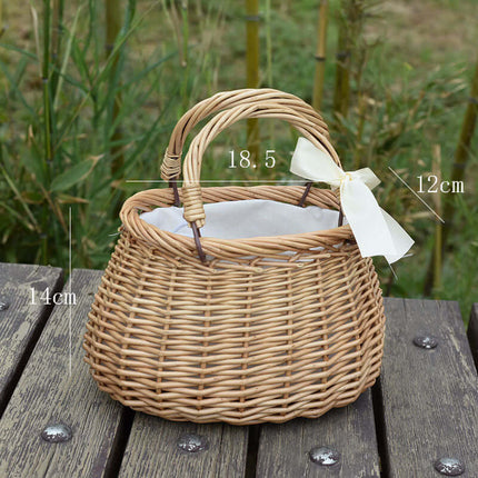 Handmade Woven Rattan Flower Basket with a white ribbon, ideal for adding a charming touch to picnic