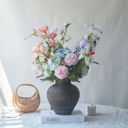 Realistic artificial Peony flower arrangement in a vase with multi-colored flowers for elegant table decor.