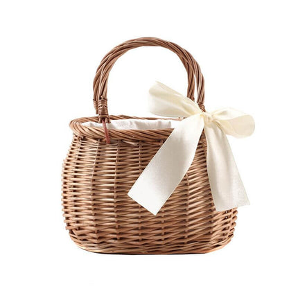 Handmade Woven Rattan Flower Basket adorned with a white ribbon, ideal for creating a stylish and natural floral - holding presentation.