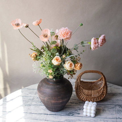 Hand tied Table Flower Arrangement showcasing lovely blooms in a dark vase, great for bringing a charming accent to interior decor.