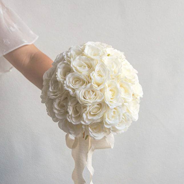 High-Quality artificial cream white silk rose bridal bouquet held by a bride.