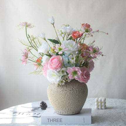 Handmade Pink-white Silk artificial flower arrangement in a decorative vase with a soft background.
