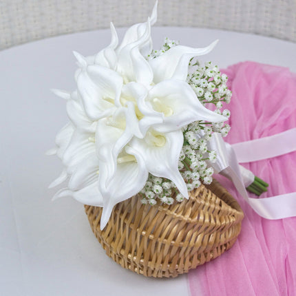 Handmade lifelike artificial white calla lily bouquet arranged in a wicker basket for weddings.