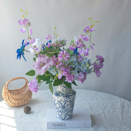 Handmade Clematis realistic artificial flower bouquet in decorative blue and white vase, vibrant colors and lifelike arrangement.