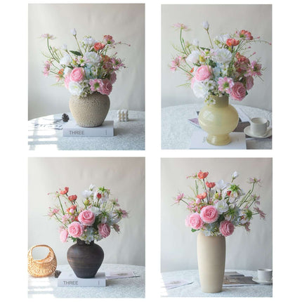 Handmade Pink-white Silk artificial flower arrangement in four decorative vases on a table.